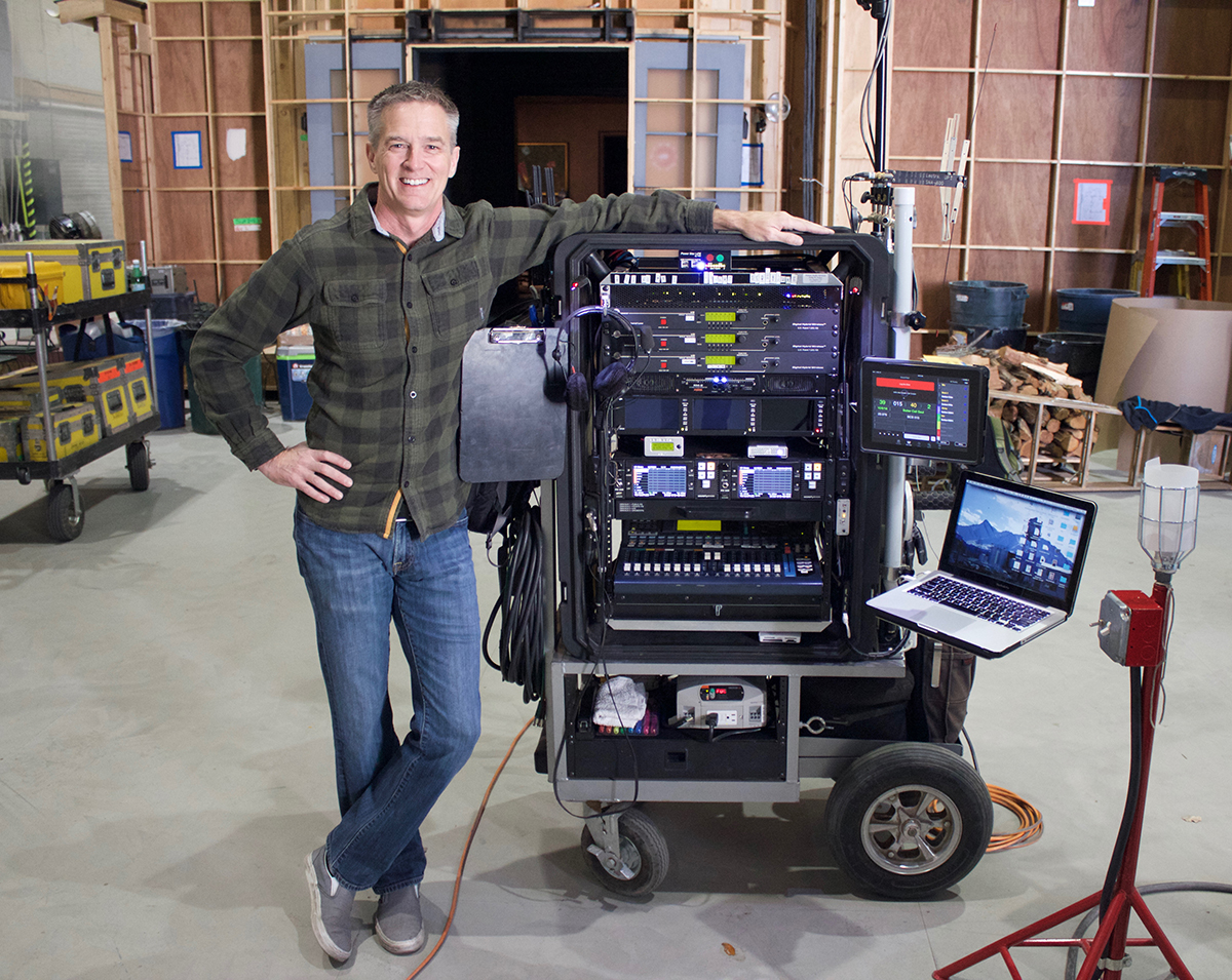 production sound mixer Phillip W. Palmer와 여러 화면·recorder·mixing surface·노트북이 놓인 sound cart